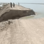 Gushing floodwaters burst through Main Nara Valley Drain near Dadu district