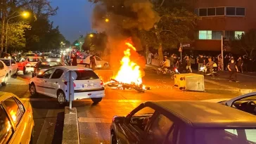 Iranian protesters set fire to police station as unrest over woman’s death spreads