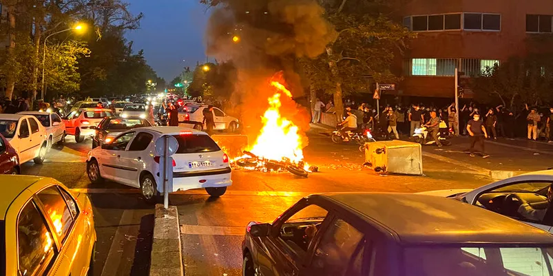 Iranian protesters set fire to police station as unrest over woman’s death spreads